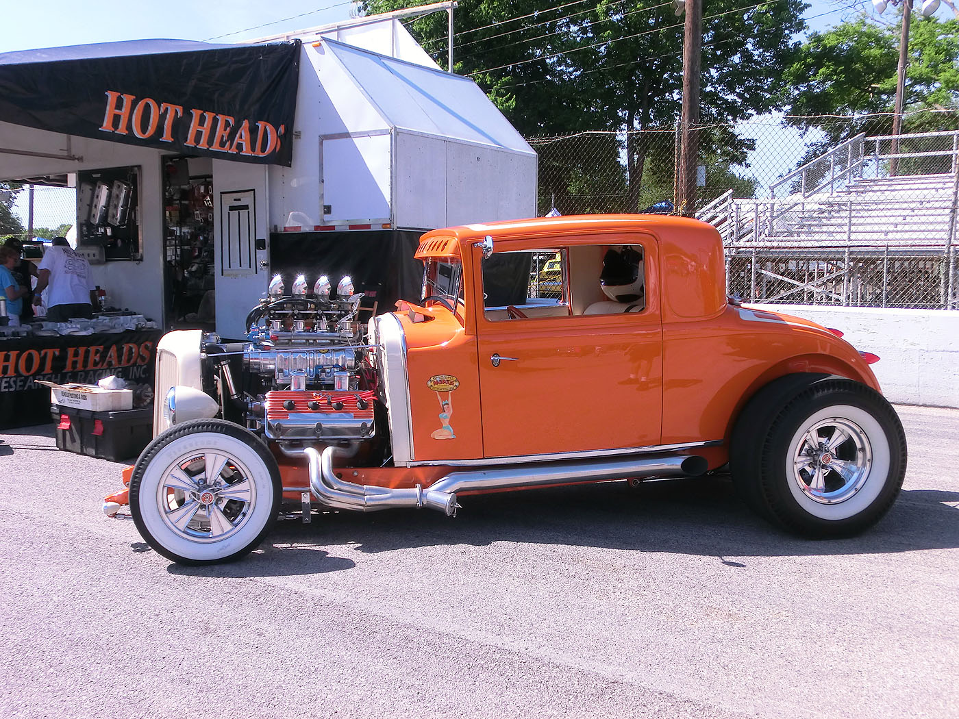 Orange hot rod coupe with a big blown engine, trackside