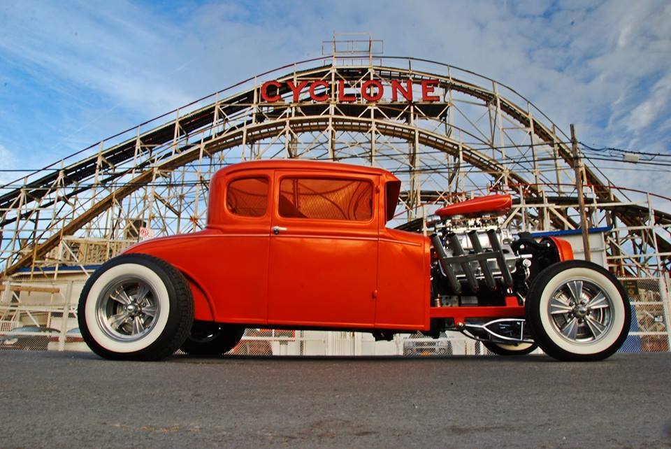 Orange hot rod coupe parked in front of the Cyclone roller coaster at Coney Island, on Radir whitewalls