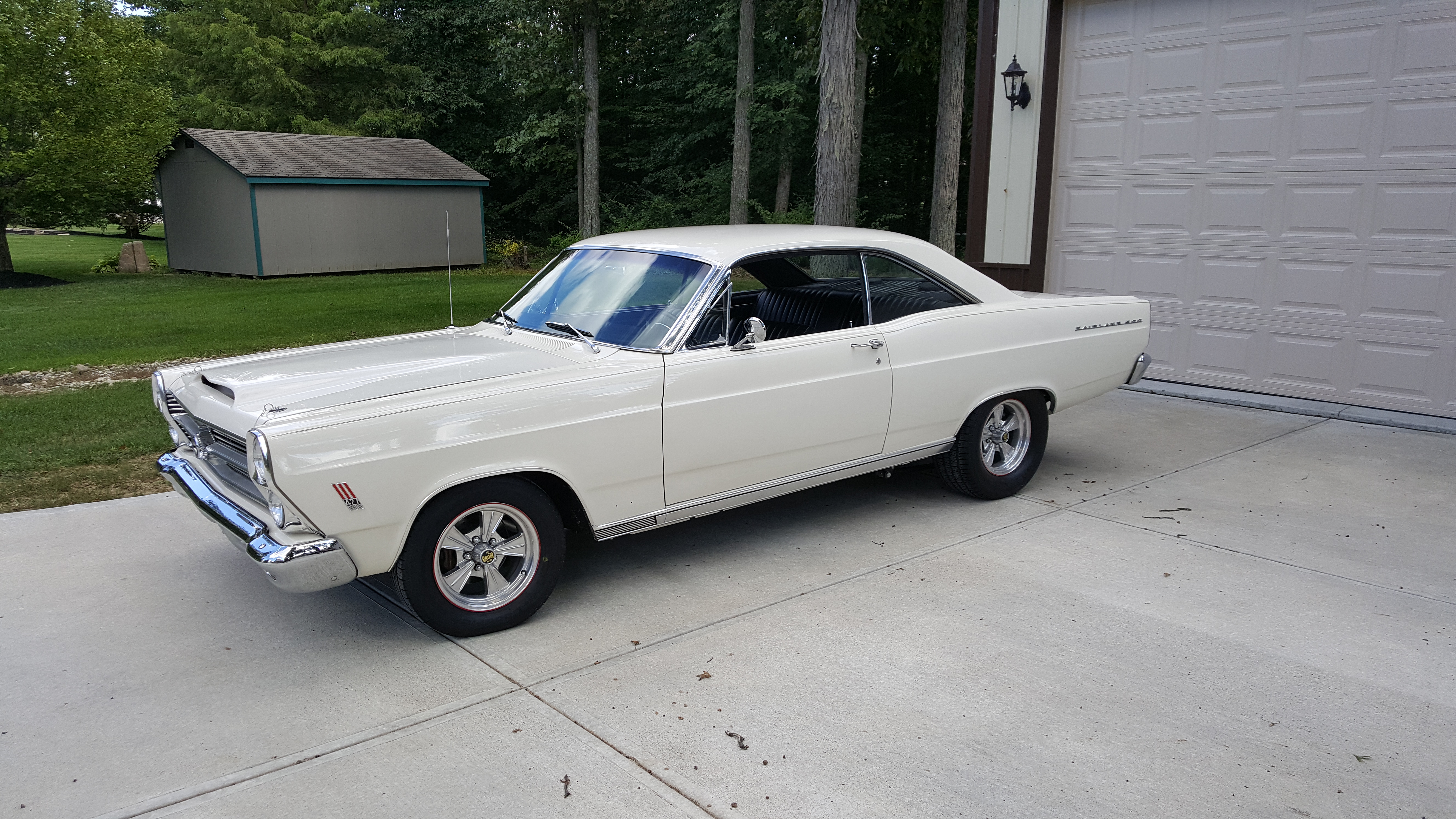 White 1966 Ford Fairlane GT muscle car in a driveway