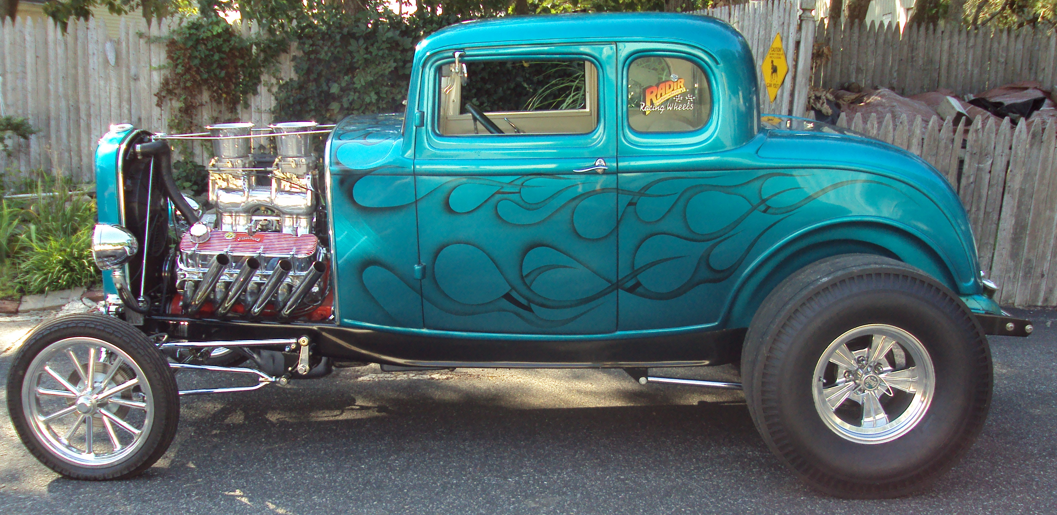 Teal flamed 1932 five-window coupe with a Radir Racing Wheels window decal