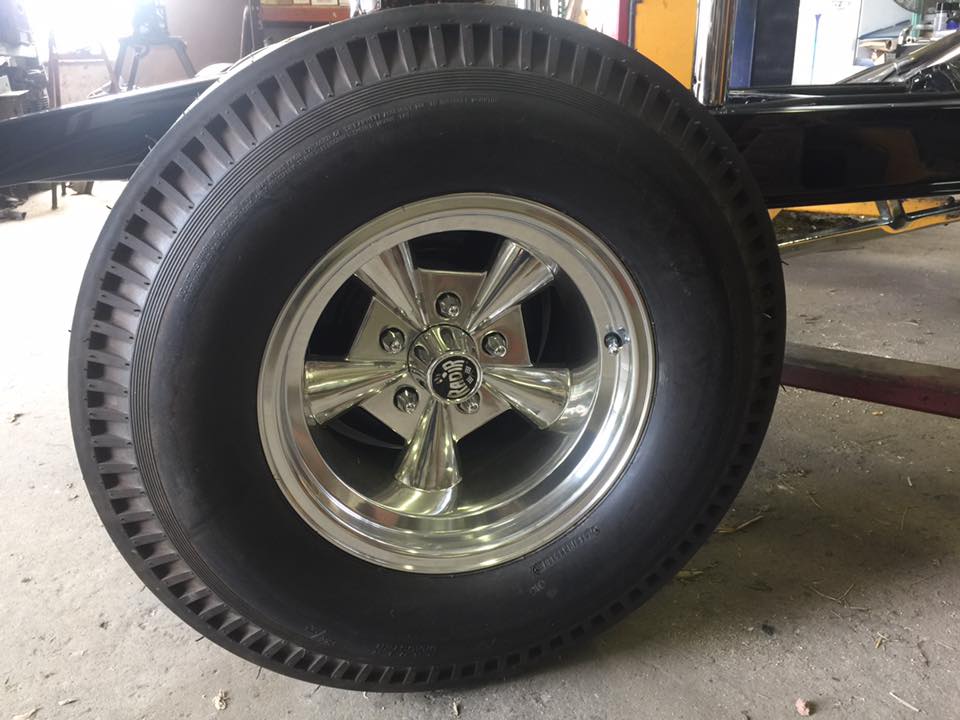 Close-up of a Radir wheel with visible hub logo, in a garage