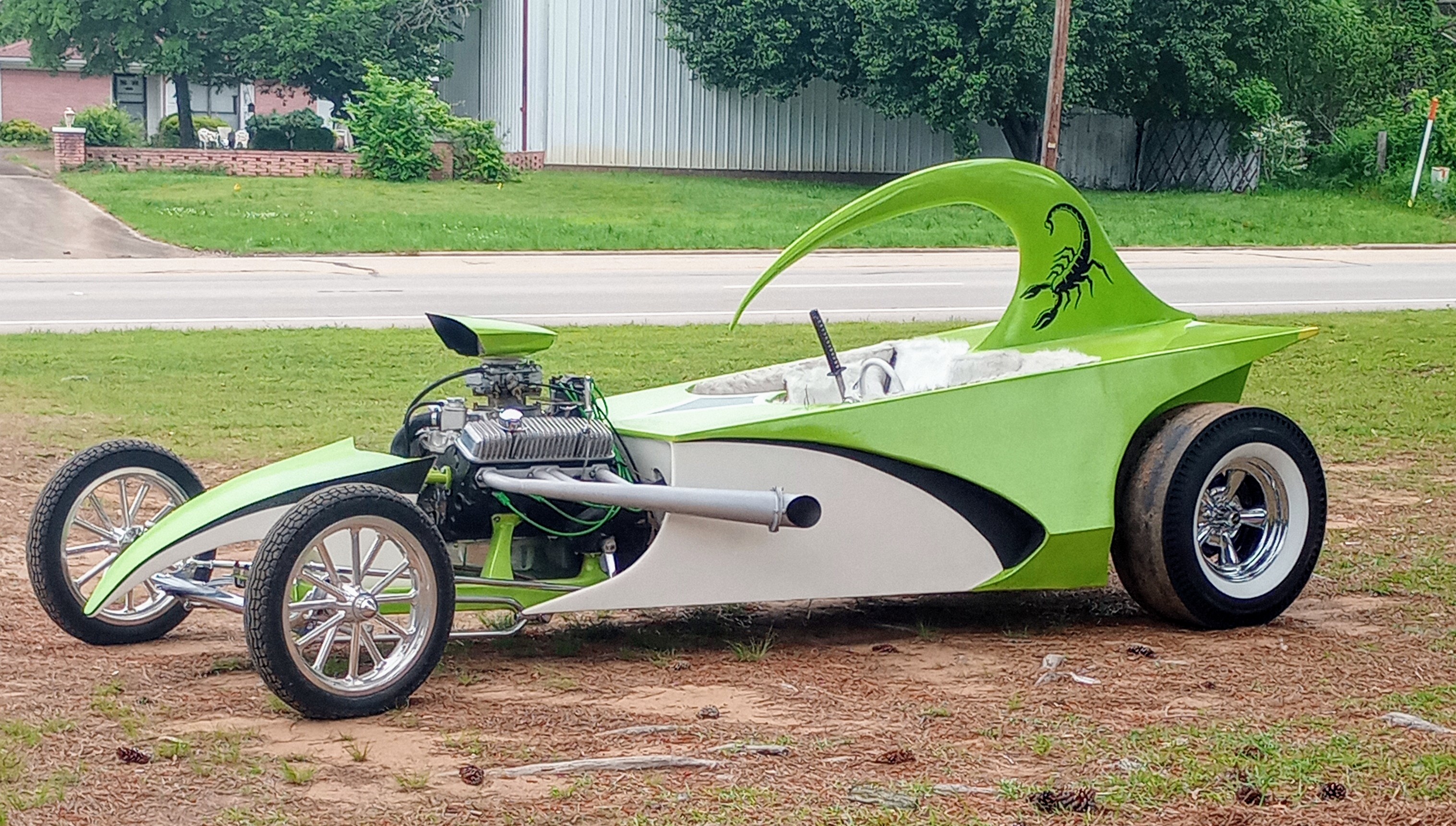 Green and white custom show dragster with a scorpion graphic