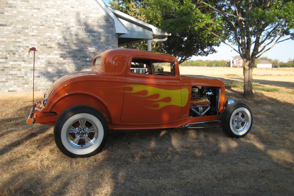 Candy orange 1932 three-window coupe with yellow flames on Radir whitewalls